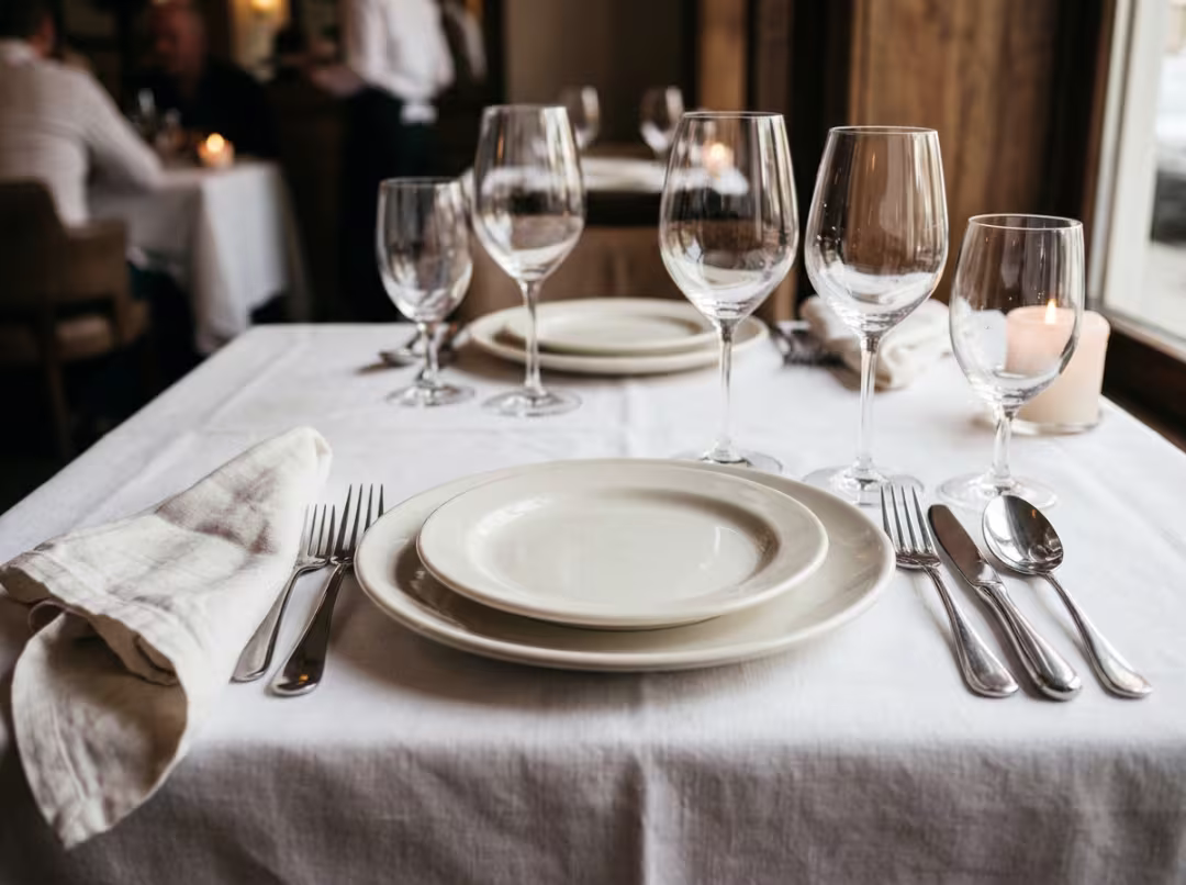 Restaurant table set with plates and glassware Restaurant table set with plates and glassware
