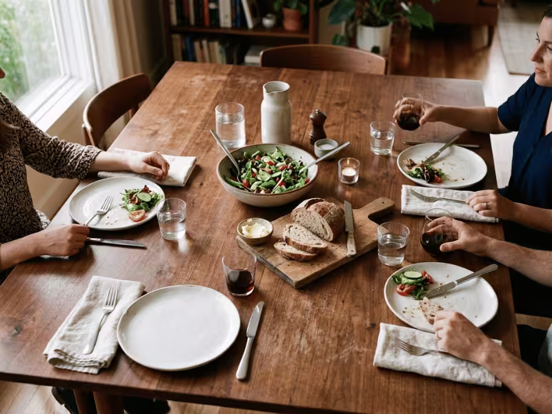 Casual dinner table with one plate, fork, knife, and glass per seat Casual dinner table with one plate, fork, knife, and glass per seat