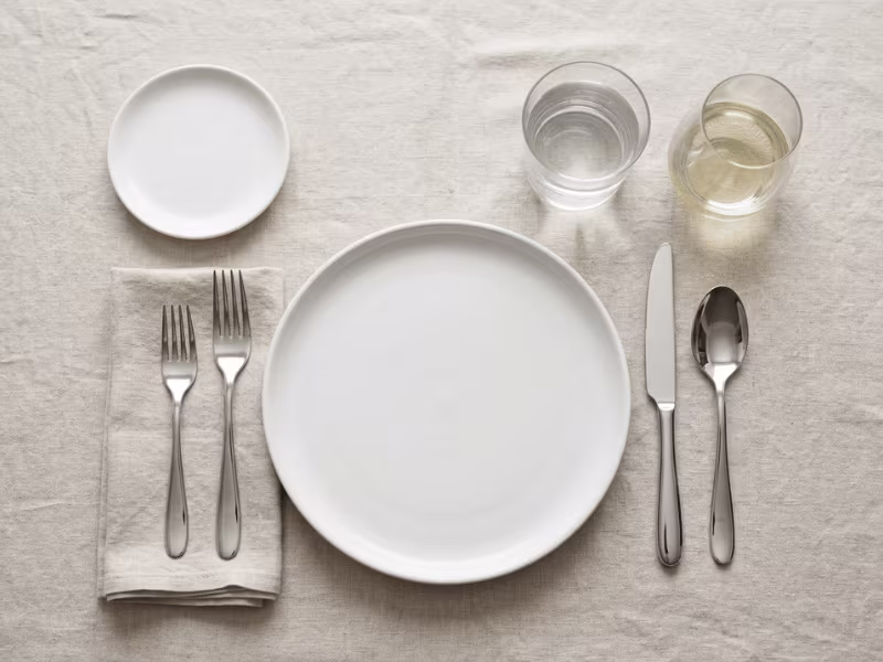 Overhead view of an informal place setting with forks on the left Overhead view of an informal place setting with forks on the left